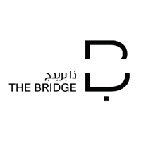 Logo of The Bridge with Arabic text and stylized letter B.